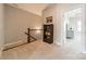 Upstairs hallway with carpet, built-in bookcase, and view into a bedroom at 15133 Rocky Bluff Loop, Davidson, NC 28036