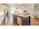 Gourmet kitchen island with sink, granite countertops, stainless appliances, and hardwood flooring at 15133 Rocky Bluff Loop, Davidson, NC 28036