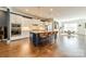 Spacious kitchen featuring a large island with seating, stainless appliances, and open dining area at 15133 Rocky Bluff Loop, Davidson, NC 28036