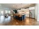 Open-concept kitchen with island seating, stainless appliances, flowing into a comfortable living area at 15133 Rocky Bluff Loop, Davidson, NC 28036