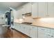 Well-appointed kitchen boasts granite countertops, stainless steel appliances, and crisp white cabinetry at 15133 Rocky Bluff Loop, Davidson, NC 28036