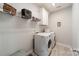 Well-lit laundry room with modern appliances, upper cabinets, and wire shelving at 15133 Rocky Bluff Loop, Davidson, NC 28036