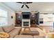 Open living room featuring a fireplace, TV, shelving units, and access to the kitchen at 15133 Rocky Bluff Loop, Davidson, NC 28036