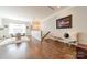 A well-lit living room features hardwood floors, modern decor, and an inviting seating area with a round table at 15133 Rocky Bluff Loop, Davidson, NC 28036