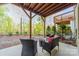 Outdoor patio with comfortable seating area surrounded by manicured landscaping and a tree lined backdrop at 15133 Rocky Bluff Loop, Davidson, NC 28036