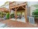 Cozy back patio with outdoor seating, overhead deck, and landscaping at 15133 Rocky Bluff Loop, Davidson, NC 28036