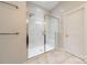 Bathroom featuring a walk-in shower with glass door and tiled walls at 15133 Rocky Bluff Loop, Davidson, NC 28036