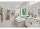 Bright bathroom features a soaking tub, dual vanities, and a large window with natural light at 167 Glenn Dr, Mooresville, NC 28115