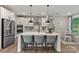 Modern kitchen with white cabinets, stainless steel appliances, a center island, and an adjacent breakfast nook at 167 Glenn Dr, Mooresville, NC 28115