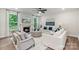 Spacious living room with a fireplace, white sofas, stylish decor, and large windows offering natural light at 167 Glenn Dr, Mooresville, NC 28115