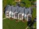 Stunning aerial view of multi-story condos with balconies, green lawns, and mature trees offering serene residential living at 18700 Nautical Dr # 101, Cornelius, NC 28031
