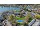 Aerial view featuring a tennis court and lush landscaping near the lake and marina at 18700 Nautical Dr # 101, Cornelius, NC 28031