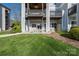 The condo features a private back patio with outdoor furniture and a lawn at 18700 Nautical Dr # 101, Cornelius, NC 28031