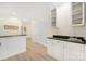 Elegant wet bar area with granite countertops and storage cabinets, perfect for entertaining at 18700 Nautical Dr # 101, Cornelius, NC 28031