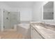 Lovely bathroom with a glass-enclosed shower, soaking tub, and granite topped vanity at 18700 Nautical Dr # 101, Cornelius, NC 28031