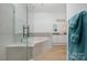 Bright bathroom featuring a glass shower and large soaking tub at 18700 Nautical Dr # 101, Cornelius, NC 28031