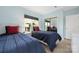 Comfortable bedroom featuring two twin beds, blue bedding, and a mirrored closet at 18700 Nautical Dr # 101, Cornelius, NC 28031