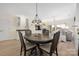 Inviting dining area with wood table, views of the living room and bar area, and a stylish light fixture at 18700 Nautical Dr # 101, Cornelius, NC 28031