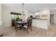 Charming dining area with modern lighting fixture and view of the kitchen bar at 18700 Nautical Dr # 101, Cornelius, NC 28031