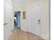 Welcoming hallway with hardwood floors and neutral paint at 18700 Nautical Dr # 101, Cornelius, NC 28031