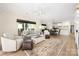 Open-concept living room with neutral tones, area rug, and view into the dining area at 18700 Nautical Dr # 101, Cornelius, NC 28031