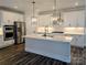 Modern kitchen with stainless steel appliances, white cabinets, and a quartz island at 1921 Hendricks St, Rock Hill, SC 29732