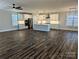 Open-concept living room and kitchen with hardwood floors, white cabinets, and modern lighting at 1921 Hendricks St, Rock Hill, SC 29732