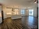 Spacious open-plan living area with kitchen, large island, hardwood floors and sliding glass doors at 1921 Hendricks St, Rock Hill, SC 29732