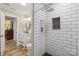 Stylish bathroom with tiled shower, white vanity, and wood-look flooring provides both functionality and modern design at 207 Blythe Mill Rd, Waxhaw, NC 28173