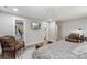 Bedroom featuring wood-look flooring, two chairs, a TV, and access to the bathroom and closet at 207 Blythe Mill Rd, Waxhaw, NC 28173