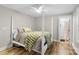 Bright bedroom features a four-poster bed, wood floors, and ensuite bathroom with white subway tile shower at 207 Blythe Mill Rd, Waxhaw, NC 28173