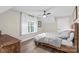 Comfortable bedroom with a queen bed, a wooden dresser, and soft natural lighting from the window at 207 Blythe Mill Rd, Waxhaw, NC 28173