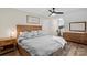 This bedroom features hardwood floors, neutral paint, and a ceiling fan at 207 Blythe Mill Rd, Waxhaw, NC 28173