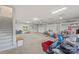 Spacious garage with multiple doors, side staircase, and ample storage space for vehicles and equipment at 207 Blythe Mill Rd, Waxhaw, NC 28173