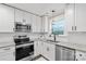 Modern kitchen featuring stainless steel appliances, granite countertops, and bright white subway tile backsplash at 207 Blythe Mill Rd, Waxhaw, NC 28173