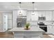 Well-appointed kitchen featuring granite countertops, stainless steel appliances, and sleek white cabinets at 207 Blythe Mill Rd, Waxhaw, NC 28173