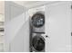 This laundry closet contains a stackable, front-loading washer and dryer at 207 Blythe Mill Rd, Waxhaw, NC 28173
