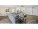 Bright living space with a seamless flow into the kitchen area, featuring a comfortable gray sectional at 207 Blythe Mill Rd, Waxhaw, NC 28173