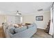 Spacious living room featuring a large gray sectional, complemented by neutral walls and dark ceiling fan at 207 Blythe Mill Rd, Waxhaw, NC 28173