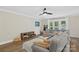 Comfortable living room with plush sectional couch, wooden shelving, and natural light from the outside at 207 Blythe Mill Rd, Waxhaw, NC 28173