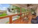 Relax on the beautiful covered porch with an outdoor ceiling fan overlooking the lush lawn and three-car garage at 207 Blythe Mill Rd, Waxhaw, NC 28173