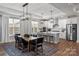 Bright open concept dining room featuring modern lighting and hardwood floors at 2085 Fordhill St, Rock Hill, SC 29362