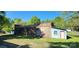 Brick building with a chimney, faded blue siding, and a grass lawn at 224 Charlotte St, York, SC 29745