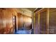 A sunlit room featuring wooden walls, multiple doors, and a window at 224 Charlotte St, York, SC 29745