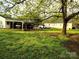 Expansive backyard featuring green grass, mature trees, and a convenient covered parking area for multiple vehicles at 2508 S Main St # 68, Concord, NC 28027