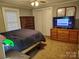 Bedroom featuring a queen-sized bed, wooden dresser, and wall mirror above a smaller dresser at 2508 S Main St # 68, Concord, NC 28027