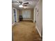 Simple bedroom featuring a ceiling fan, carpeted floors, and natural light from a large window at 2508 S Main St # 68, Concord, NC 28027