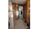 View of a hallway leading into a kitchen with white cabinets and appliances at 2508 S Main St # 68, Concord, NC 28027