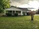 Charming one-story home with a covered front porch, manicured lawn, and mature landscaping at 2508 S Main St # 68, Concord, NC 28027
