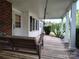 Cozy covered front porch featuring a classic wooden swing, providing a welcoming entrance at 2508 S Main St # 68, Concord, NC 28027